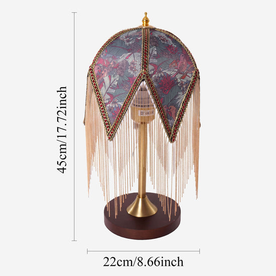 mid-century tassel table lamp beside books and evening decor