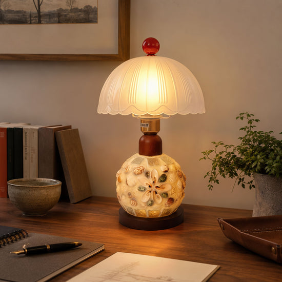 seashell mosaic table lamp adding warm light to a bedroom