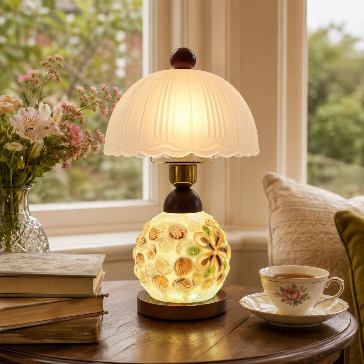seashell mosaic table lamp beside books and evening decor