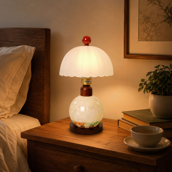 mother-of-pearl mosaic table lamp adding warm light to a bedroom