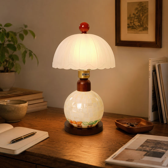 mother-of-pearl mosaic table lamp on a desk with soft ambient light
