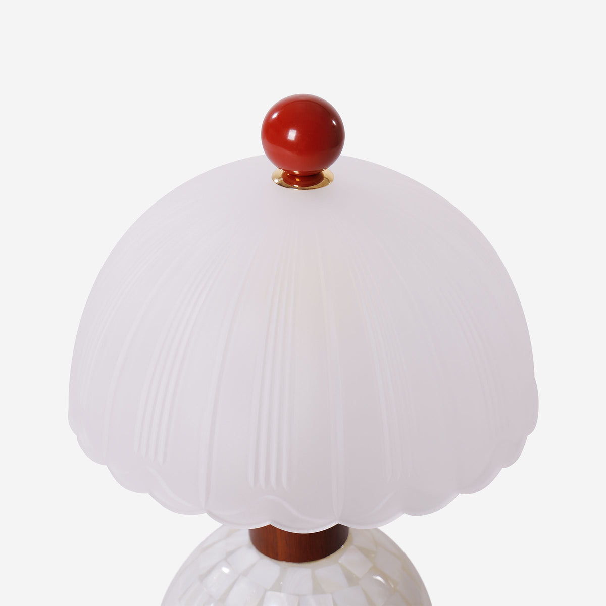 mother-of-pearl mosaic table lamp beside books and evening decor