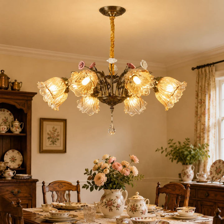 antique bronze chandelier with amber flower shades glowing above a dining table