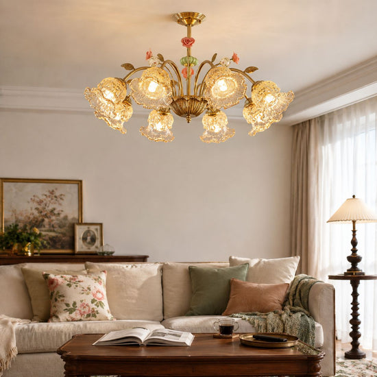 gold 8-light chandelier with pink floral glass shades adding soft light to a bedroom