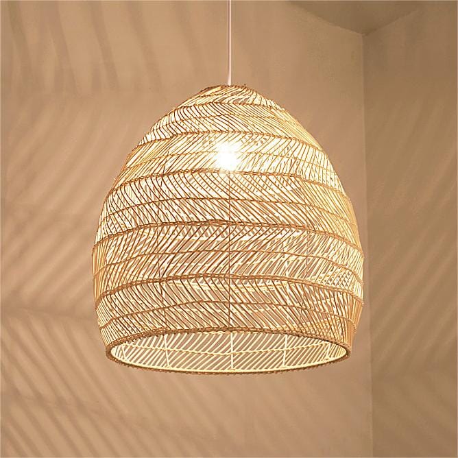 Close-up of woven rattan pendant shade glowing with a warm E27 bulb
