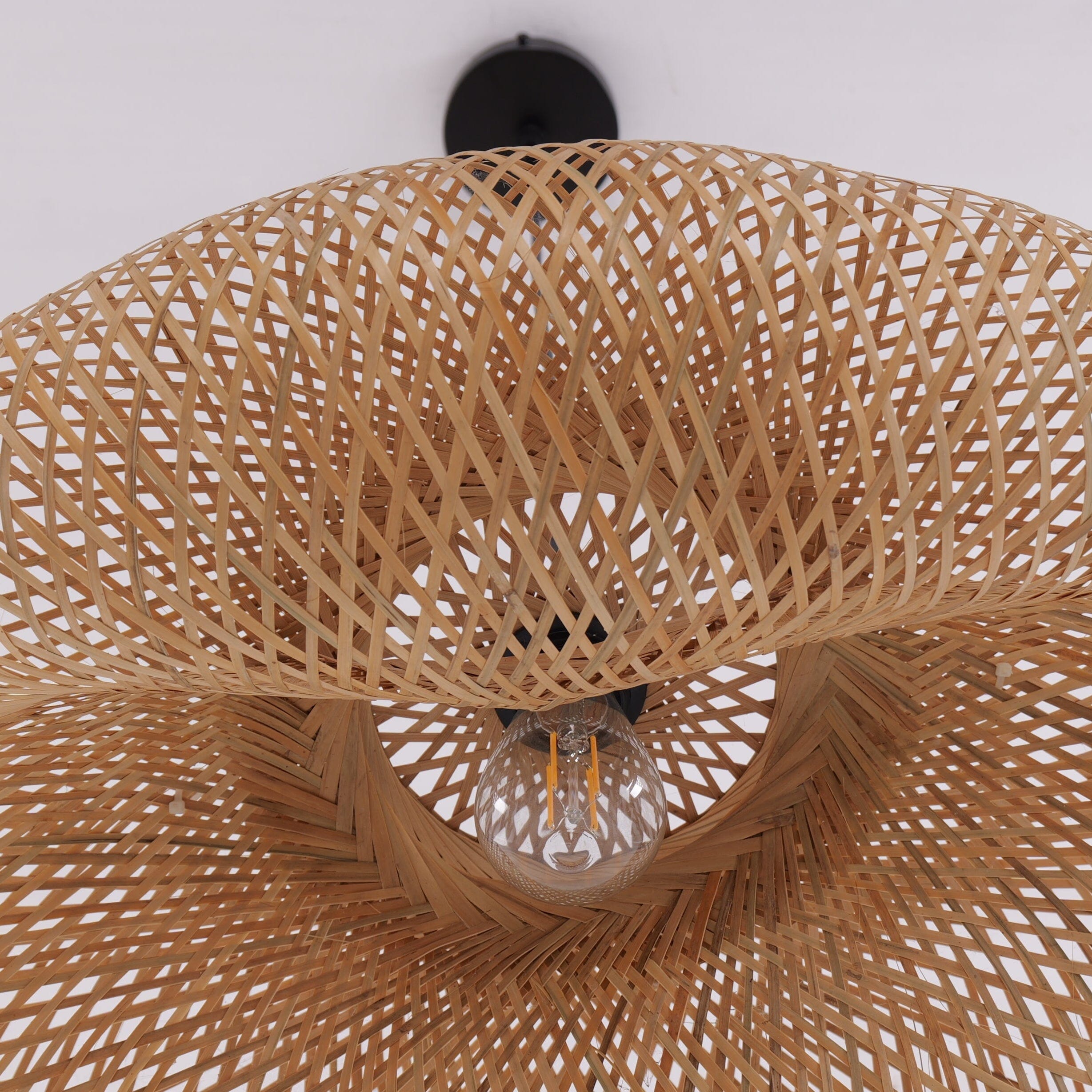 woven bamboo pendant light underside showing bulb and basket texture