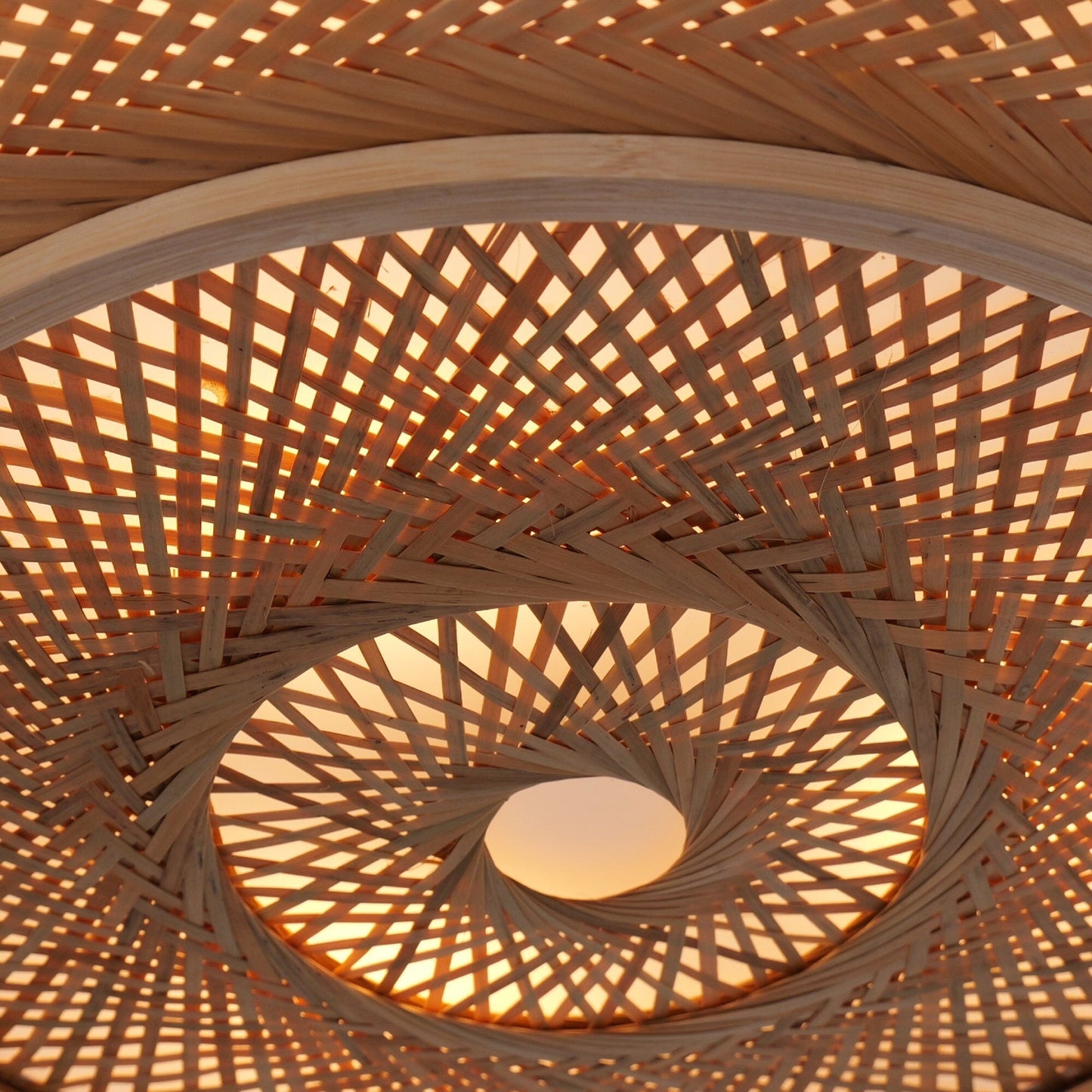 lit underside of a woven bamboo rattan shade