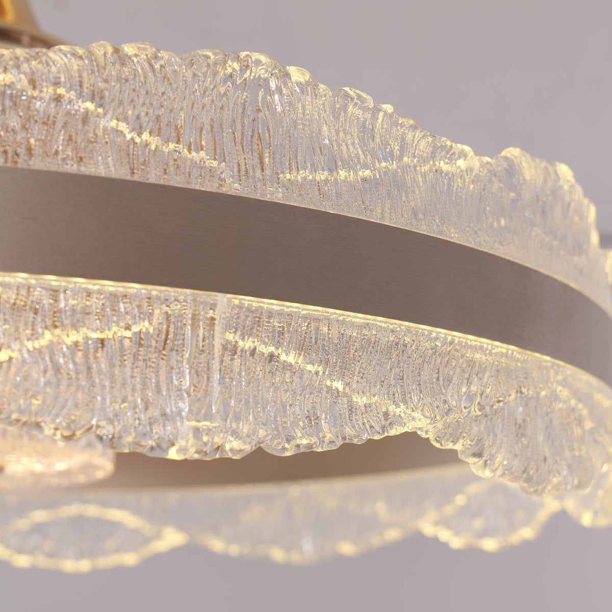 Layered crystal diffuser and warm LED glow on gold ceiling fan light
