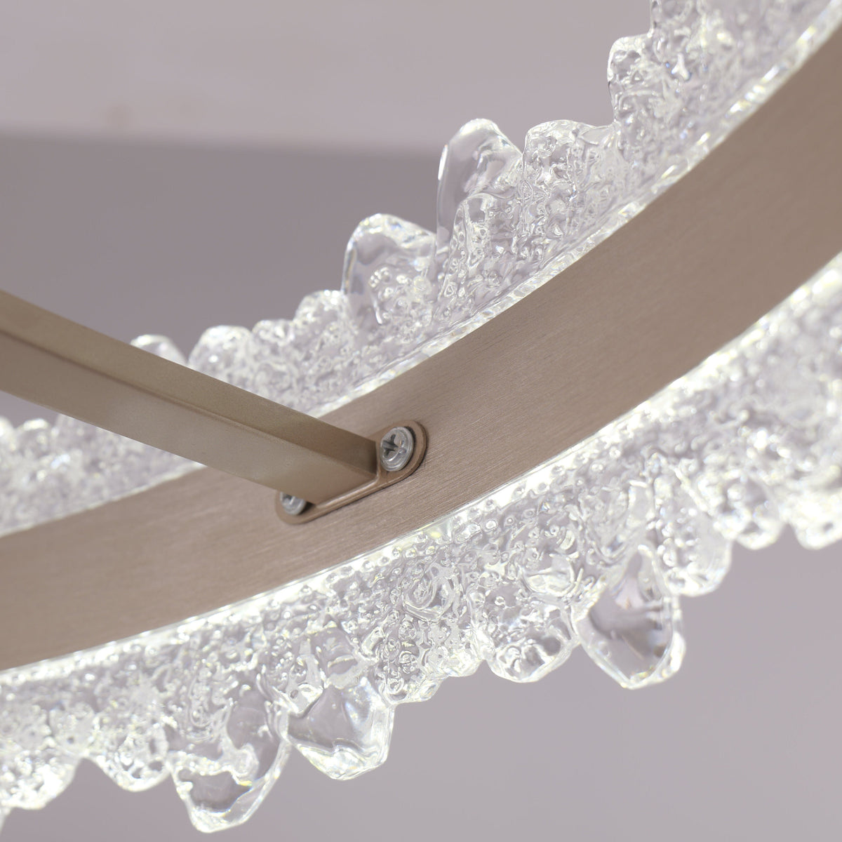 Clear retractable blade joint beside crystal diffuser on gold fan light