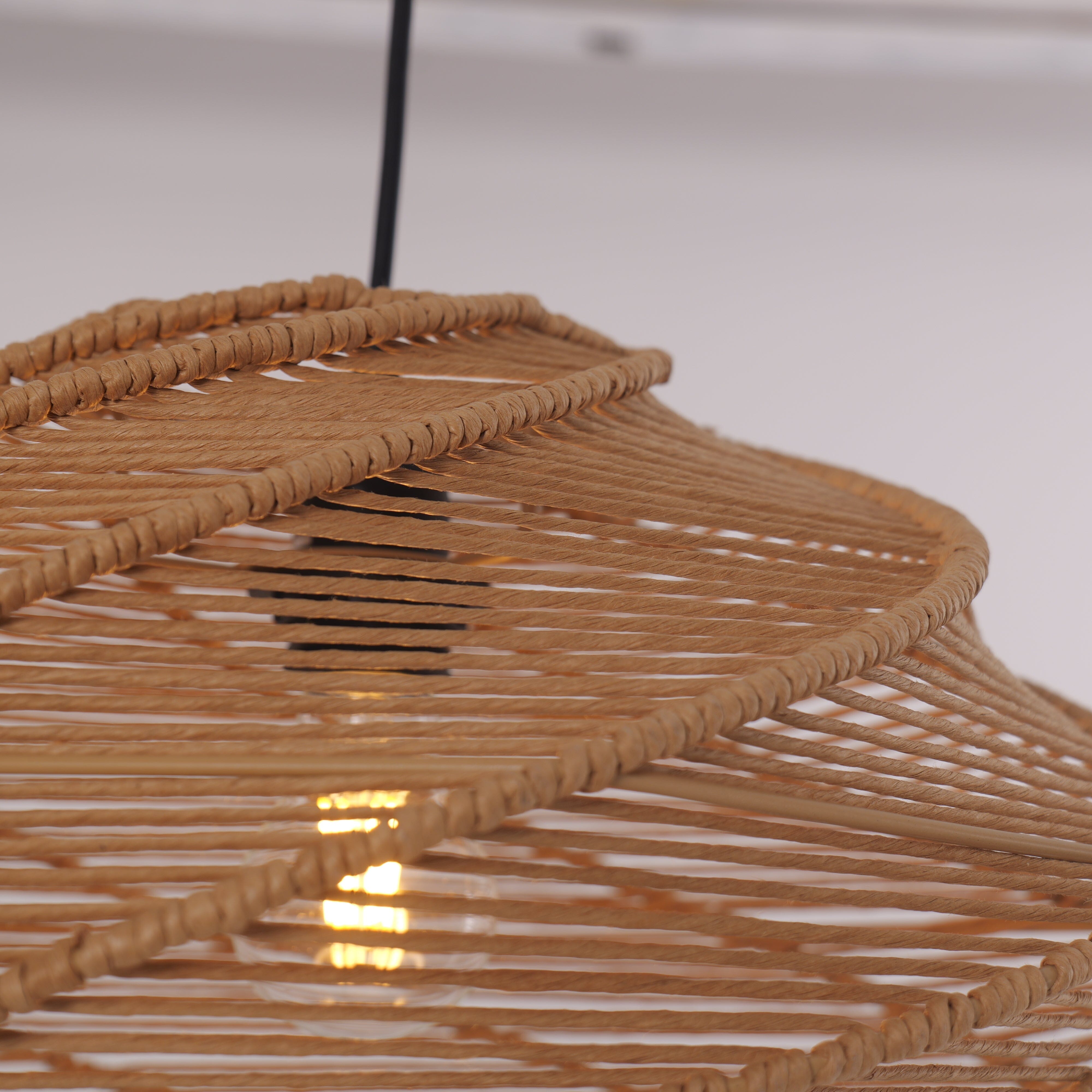 natural woven rattan pendant light close-up showing layered spiral shade