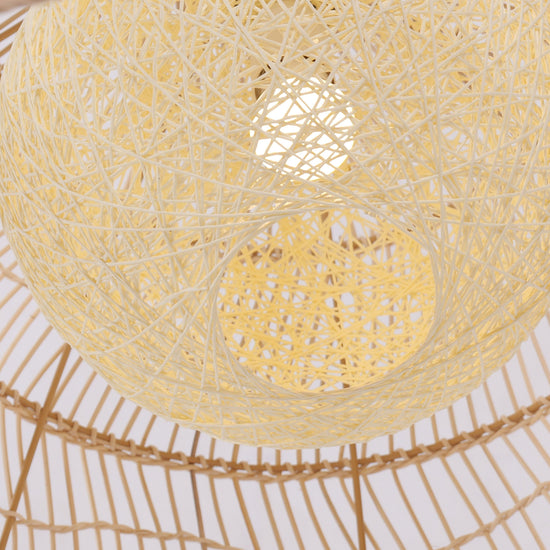 Close-up of woven rattan pendant shade with glowing yellow inner sphere