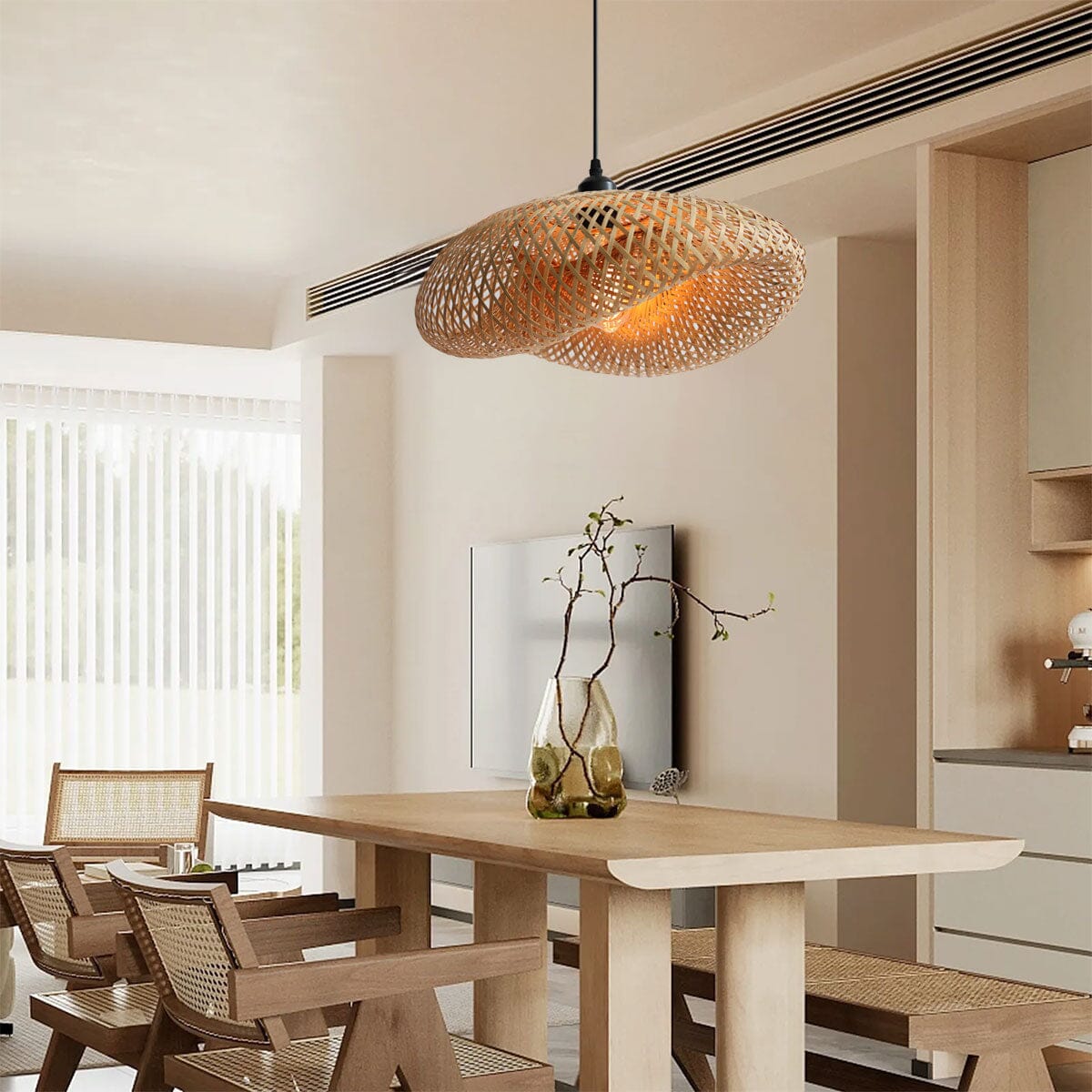woven bamboo pendant light over a pale wooden dining table