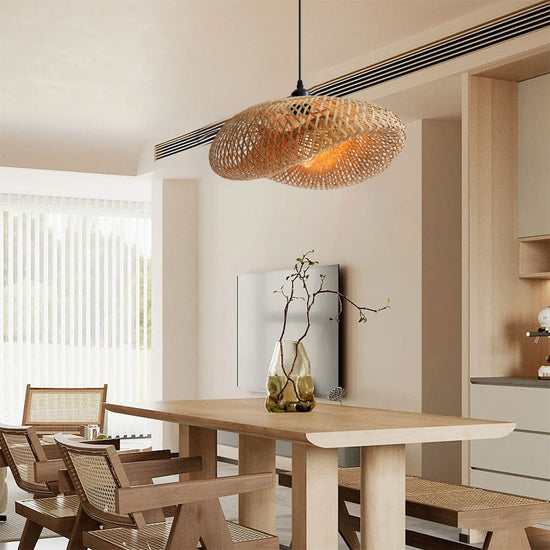 woven bamboo pendant light over a pale wooden dining table